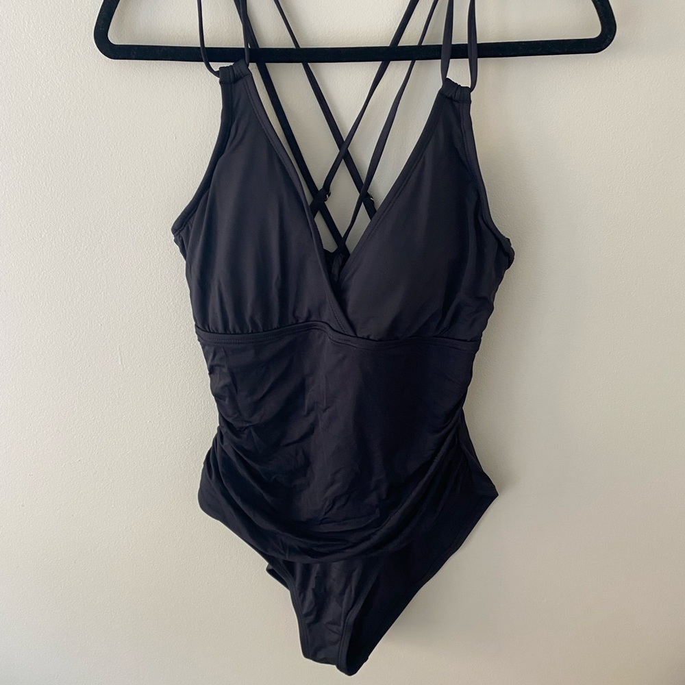Women’s black one piece bathing suit with cross straps in the back